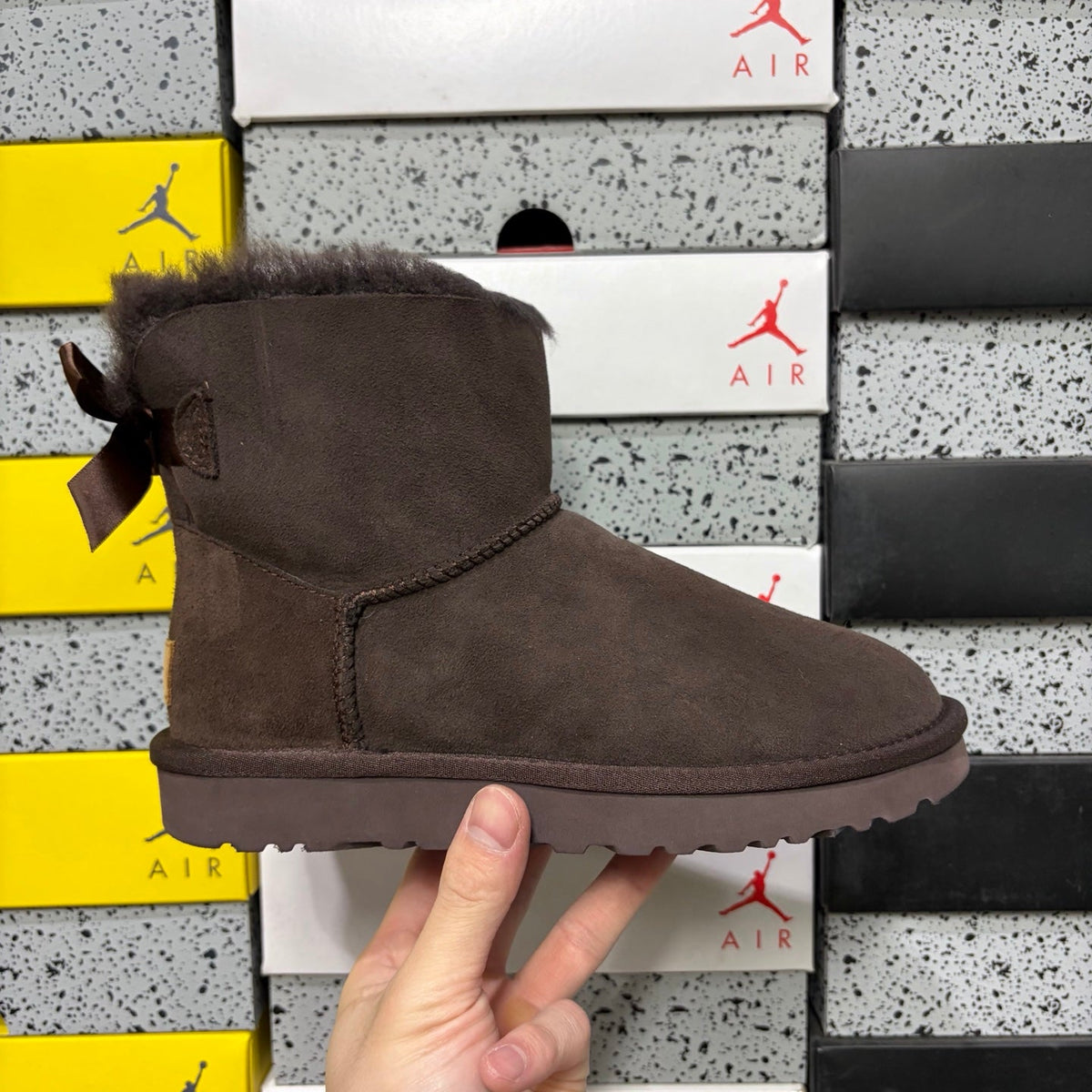 UGG Mini Bailey Bow Ankle Boot – Suede Boot with Tonal Dark Shearling Lining, Chocolate Satin Bow & Dark Sugar Sole in Chocolate